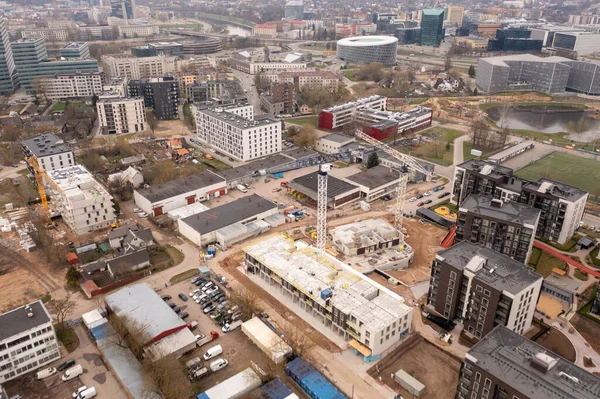 stock image Drone photography of urban construction site of multistory apartment complex in the middle of other structures during spring sunny day. High angle view