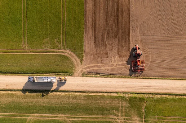 stock image Drone photography of agricultural machinery getting ready for work during spring day.