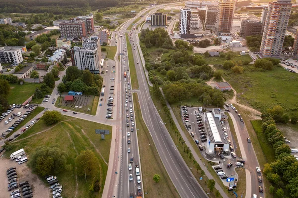 Drone photography of city's apartment complex, big road in a city during summer evening