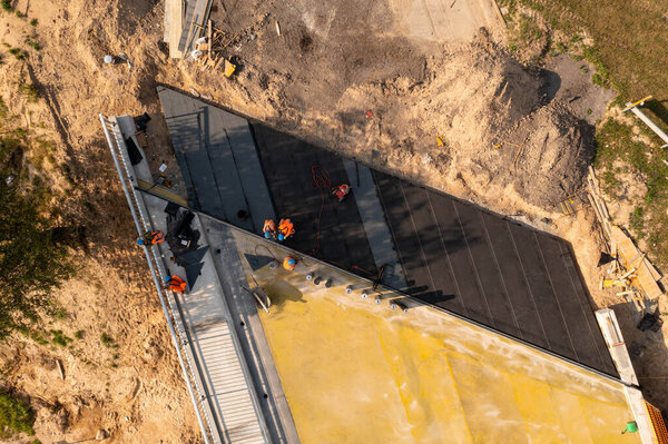 Drone photography of highway bridge being repaired during summer day. High angle view