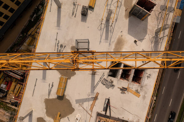 Drone photography of building construction site and a steel crane during summer day