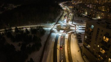 Drone photography of high intensity roadway during winter night with traffic