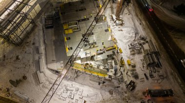 Drone photography of construction site and construction workers working during the winter night