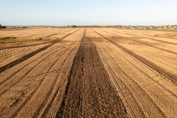 Drone photography of a harvested agriculture field during autumn sunny morning