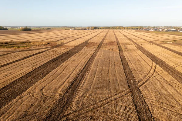 Drone photography of a harvested agriculture field during autumn sunny morning