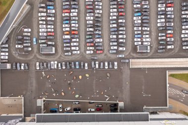 Sonbahar bulutlu bir günde alışveriş merkezinin yakınındaki neredeyse dolu otoparkın insansız hava aracı fotoğrafları.
