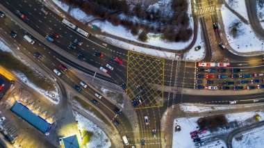 Kış bulutlu bir günde karla kaplı ana caddeden geçen insansız hava aracı fotoğrafları.