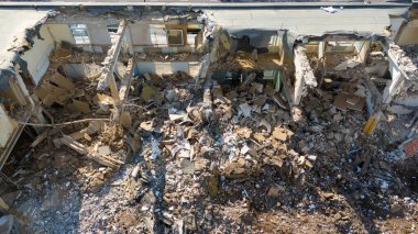 Bir evi söken ve güneşli yaz gününde rubleyi kaldıran makinelerin uzaktan çekimleri.