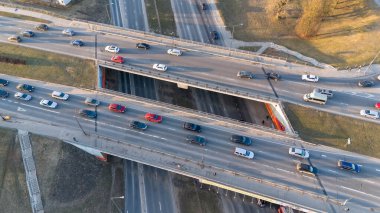Birden fazla şerit ve araçla yoğun bir otoyol kavşağının havadan görüntüsü.