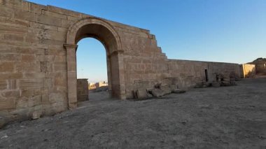 Büyük blokları ve duvarları olan eski taş kalıntıları berrak mavi gökyüzünün altında.