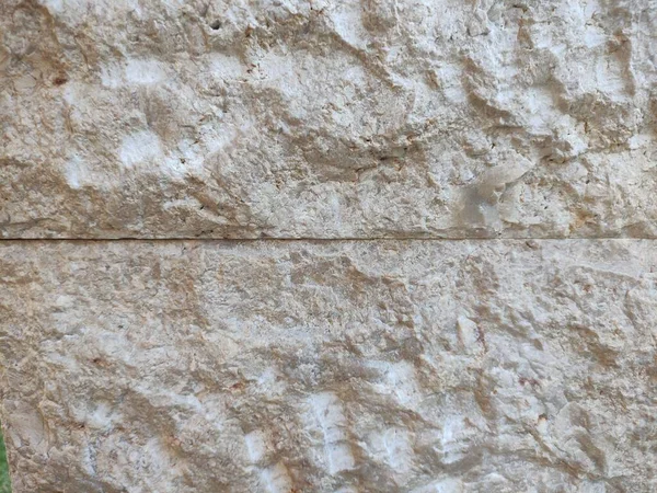brown cream stone wall texture which is usually installed on the walls of houses or luxury villas