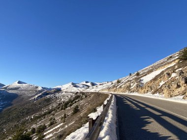 Dağ yolu, İtalya 'nın vahşi doğası Abruzzo, Santo Stefano di Sessanio' da karlı tepeler ve dağlık araziler boyunca kıvrılıyor.