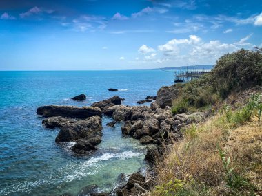 Rocca San Giovanni, Abruzzo 'nun kayalık sahillerinde Adriyatik Denizi' nin arka planında geleneksel bir balıkçılık platformu olan bir trabocco manzarası.