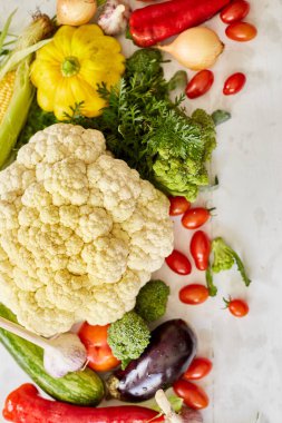 Top view of different fresh farm vegetables on the white background, frame, Autumn harvest and healthy organic bio food concept, Garden produce and harvested vegetable, copy space.