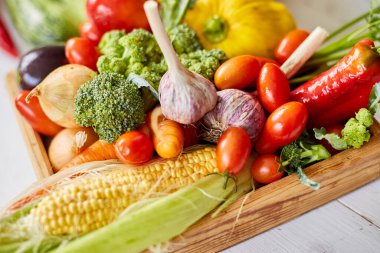 Wooden box with different fresh farm vegetables on the white background, Autumn harvest and healthy organic bio food concept, Garden produce and harvested vegetable