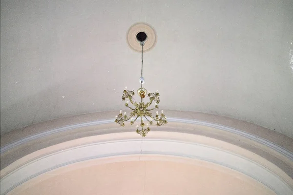 Chandelier hanging in old church. Film grain