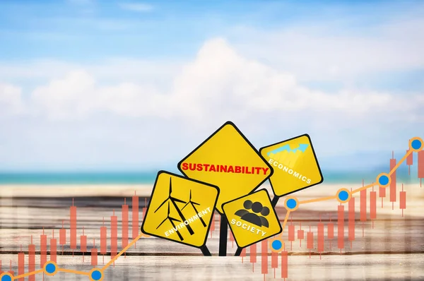Environment, society and economics written on yellow sign on plank and beach background. Renewable clean energy investment for sustainability concept and alternative energy idea