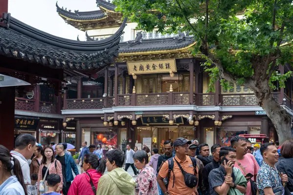 stock image Shanghai, June 06, 2024: Tourist visit to Yuyuan Bazaar in Shanghai. This is bustling energy of Shanghai's most famous commercial street, with a pedestrian mall surrounded by traditional and luxury shopping opportunities