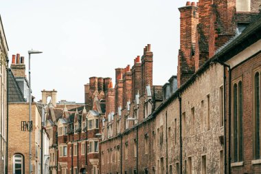 Cambridge, İngiltere 'de tuğla binalar ve bacalarla kaplı dar bir cadde..