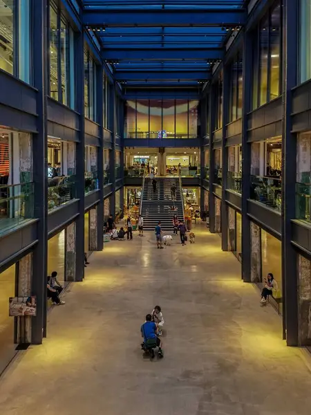 stock image Hong Kong, China - July 21, 2024 : A modern, open space in Hong Kong, China, with a large, open space and a staircase in the middle.  People are walking and sitting around.