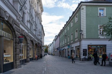 Regensburg, Almanya - 06 Kasım 2023: Regensburg, Almanya 'da tarihi binalar ve dükkanlarla dolu bir kaldırım taşı caddesi.