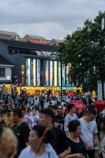 stock image suzhou, China - June 10, 2024 : Crowded street in Suzhou, China with shops and people walking by.