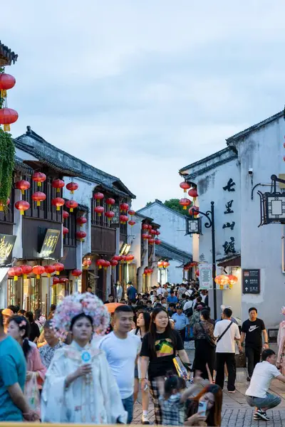 stock image suzhou, China - June 10, 2024 : A bustling street in Suzhou, China, lined with traditional buildings and decorated with red lanterns.