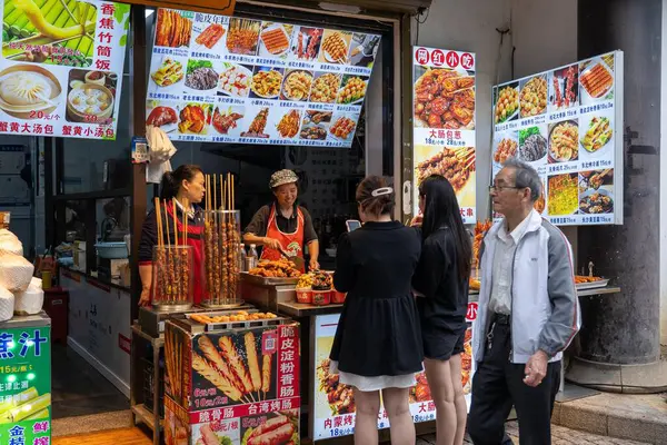 stock image Suzhou, China - June 11, 2024 : Street food vendor in Suzhou, China, with a variety of grilled meats and other treats on offer.