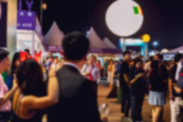 stock image Blurry night scene of a crowd of people in Hong Kong, China. The background is out of focus, with bokeh lights.