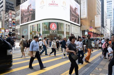 Hong Kong, Çin - 3 Temmuz 2024: Hong Kong, Çin 'de yayaların sarı yaya geçitleriyle caddeyi geçtiği işlek bir cadde. Sokak yüksek binalarla dolu..