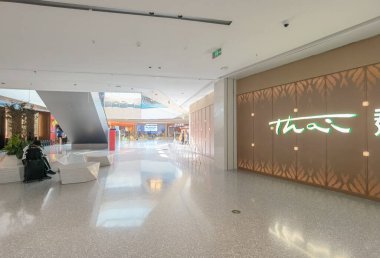 Shenzhen, China - October 25, 2024 : A modern shopping mall interior with a restaurant sign in the background. clipart