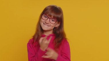 Overjoyed delighted young preteen child girl kid showing rock n roll gesture by hands, cool sign, shouting yeah with crazy expression, dancing emotionally rejoicing in success. Little toddler children