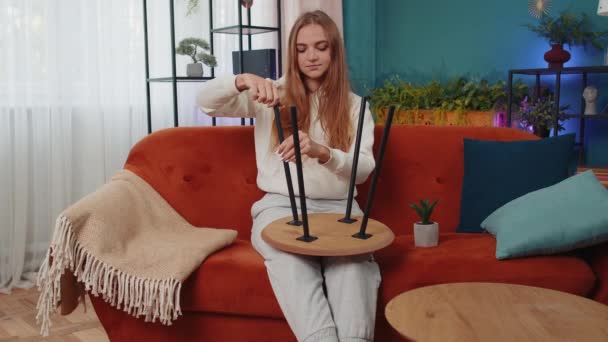 Portrait Caucasian Adult Girl Finishing Assembling Furniture Home Sitting Orange — Stockvideo