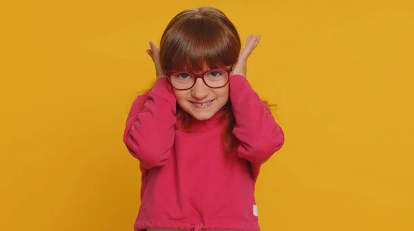 Dont want to hear, listen. Frustrated annoyed irritated young toddler school girl in glasses covering ears, gesturing No, avoiding advice ignoring unpleasant noise loud voices. Teen female child kid