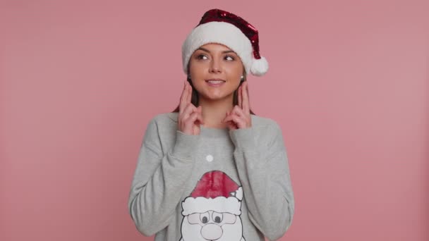 サンタ 句のセーターの若い女性はクリスマス休暇を祝いますギフトボックスを受け取り 素敵なプレゼント 予期しない驚きに満足して見て楽しく笑っています 女の子オンピンクスタジオの背景 — ストック動画