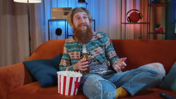 Nadšený Vousatý Hippie Mladý Muž Sedí Pohovce Jíst Popcorn Občerstvení — Stock video