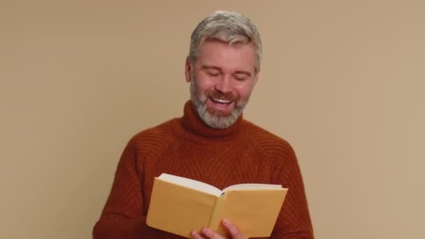 Happy Middle Aged Man Reading Funny Interesting Fairytale Story Book — Vídeos de Stock