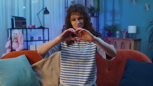 Love You Happy Woman Curly Hairstyle Home Couch Makes Symbol — Vídeo de stock