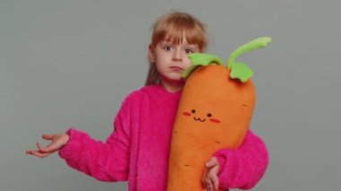 I dont know what to say. Confused young preteen child girl kid feeling embarrassed about ambiguous question, having doubts, no idea, being clueless and uncertain. Toddler children on gray background