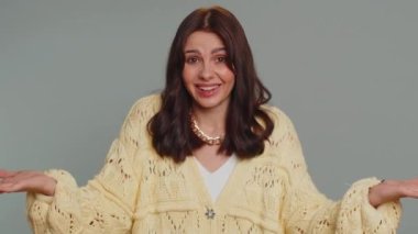 What Why. Sincere irritated woman raising hands in indignant expression asking reason of failure demonstrating disbelief irritation by trouble. Young confused pretty girl isolated on gray background