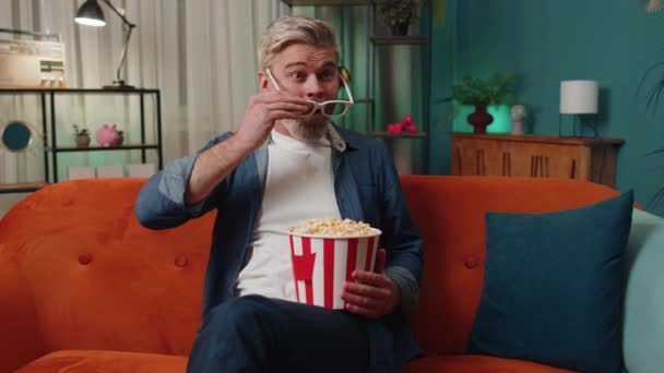 Excited Bearded Middle Aged Man Sits Sofa Eating Popcorn Snacks — Stockvideo