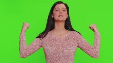 I am strong and independent. Proud success woman showing biceps and looking confident, feeling power strength to fight for rights energy to gain success win. Young adult girl on chroma key background