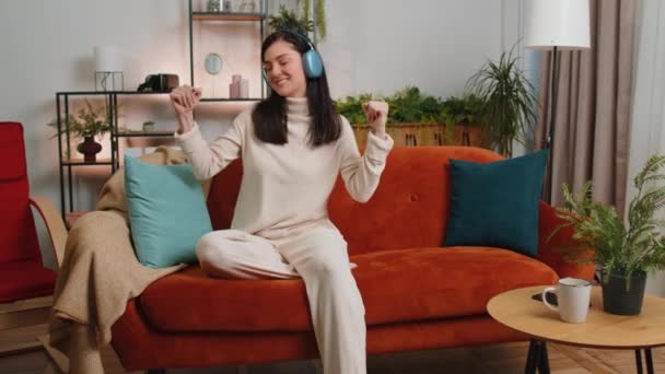 Happy Overjoyed Brunette Woman Wireless Headphones Relaxing Sitting Couch Home — Stockvideo
