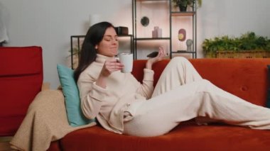 Repair work at neighbours. Irritated woman relaxing on couch cover ears with pillows annoyed by noisy neighbors suffer from headache wishes silence. Thin walls at home flat without sound insulation