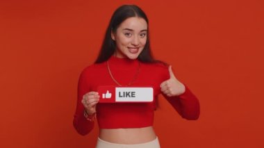 Lovely woman showing banner sign love like, comment, share. Pretty girl social media blogger waiting for online followers feedback and positive rate on internet isolated on red studio background