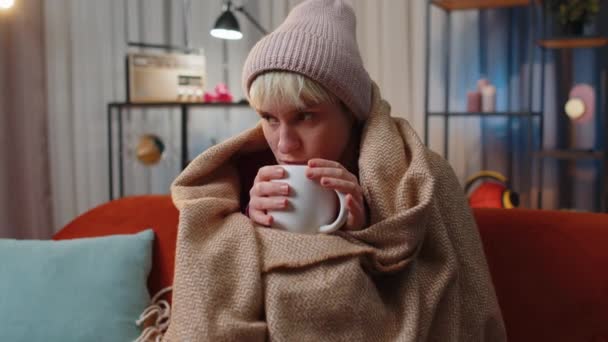 Sick Woman Wrapped Plaid Sit Alone Shivering Cold Sofa Drinking — Vídeo de Stock