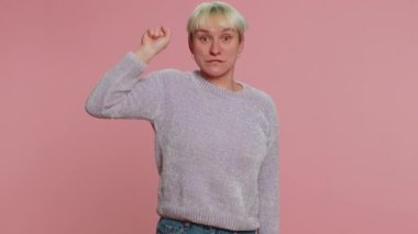 Knock-knock who is there. Confused clueless millennial woman with short hair knocking door gesture asking who is at home. Young uncertain girl isolated on pink background. Lgbt gay lesbian people