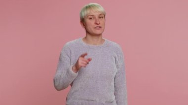 I choose you. Young woman with short hair smiling excitedly, pointing to camera, choosing lucky lottery winner, indicating to awesome you. Girl isolated on pink background. Lgbt gay lesbian people