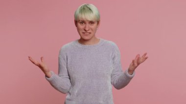 What Why. Sincere irritated woman raising hands in indignant expression asking reason of failure demonstrating disbelief irritation by troubles. Confused one girl on pink background. Lgbt gay lesbian