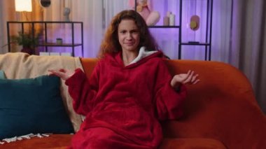 What. Why. Preteen girl raising hands in indignant expression, asking reason of failure, demonstrating disbelief irritation by troubles. Young child kid at home in evening living play room on couch